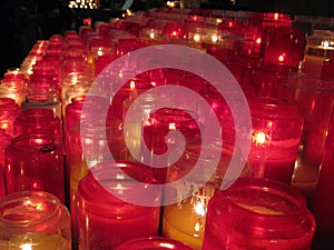 Warm and inviting red prayer candles inside the SacrÃÂ©-CÃâur, Paris